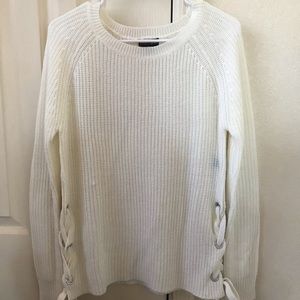 A cute white sweater that ties on the sides